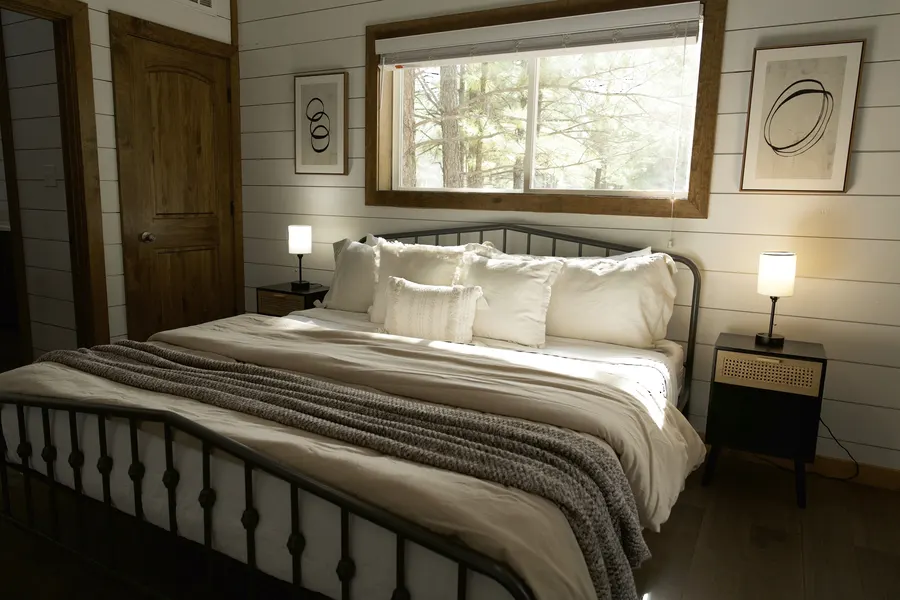 Warm guest bedroom with forest view